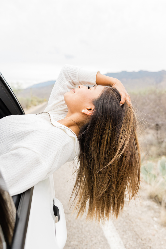 Woman Feeling the Breeze Outside the Car Window